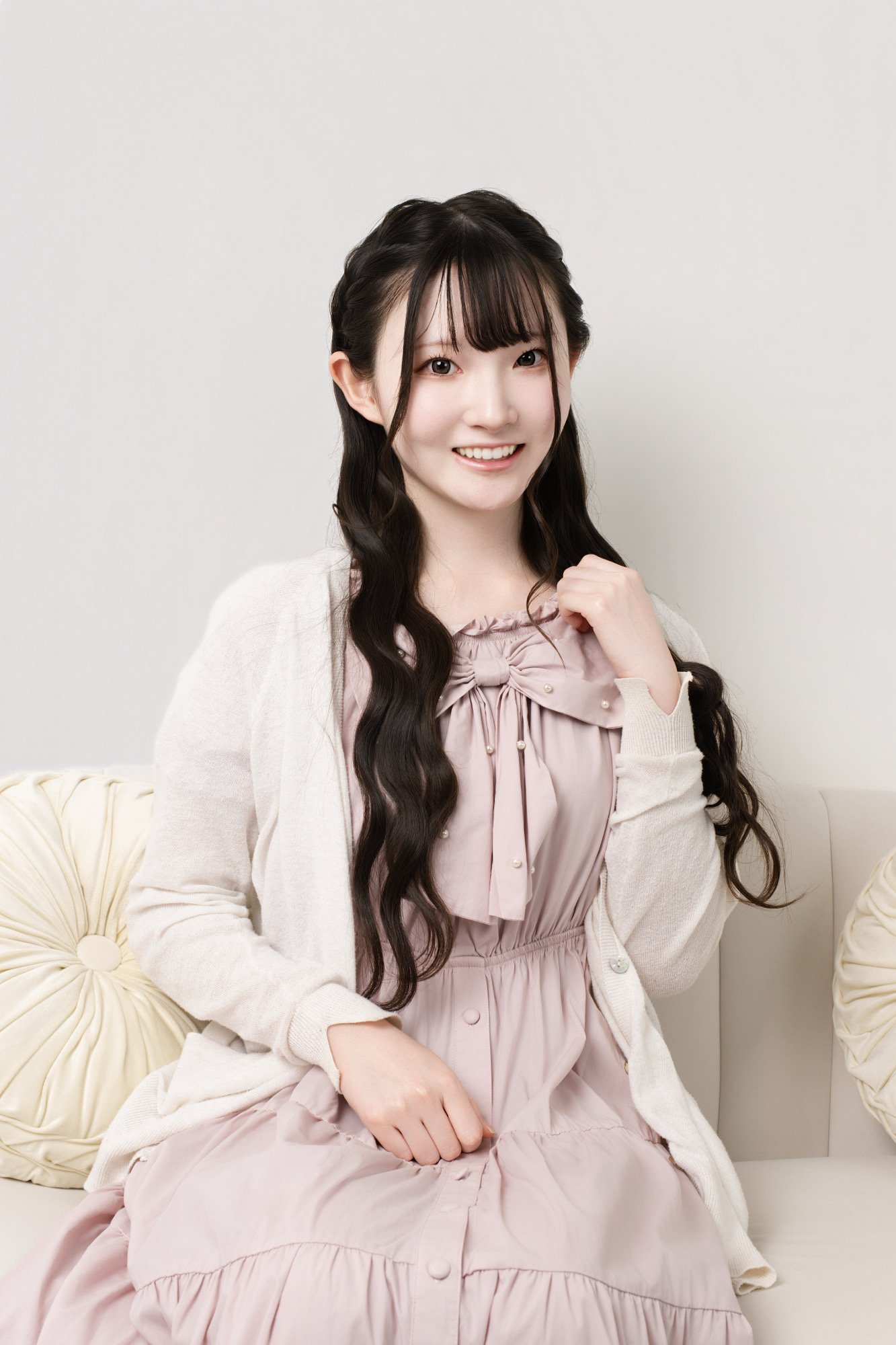 ピンクの私服で自然に笑うプロフィール写真